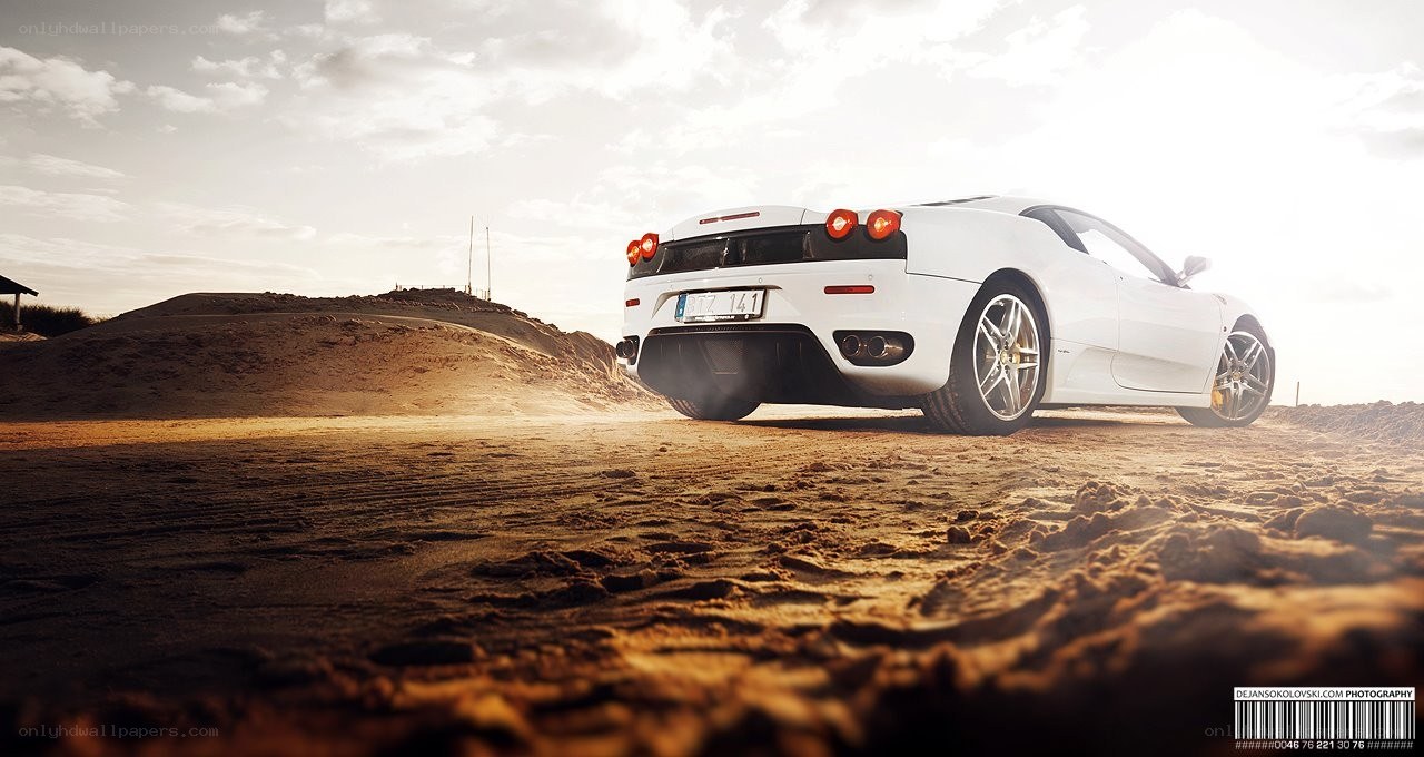 White Ferrari on a sandy beach