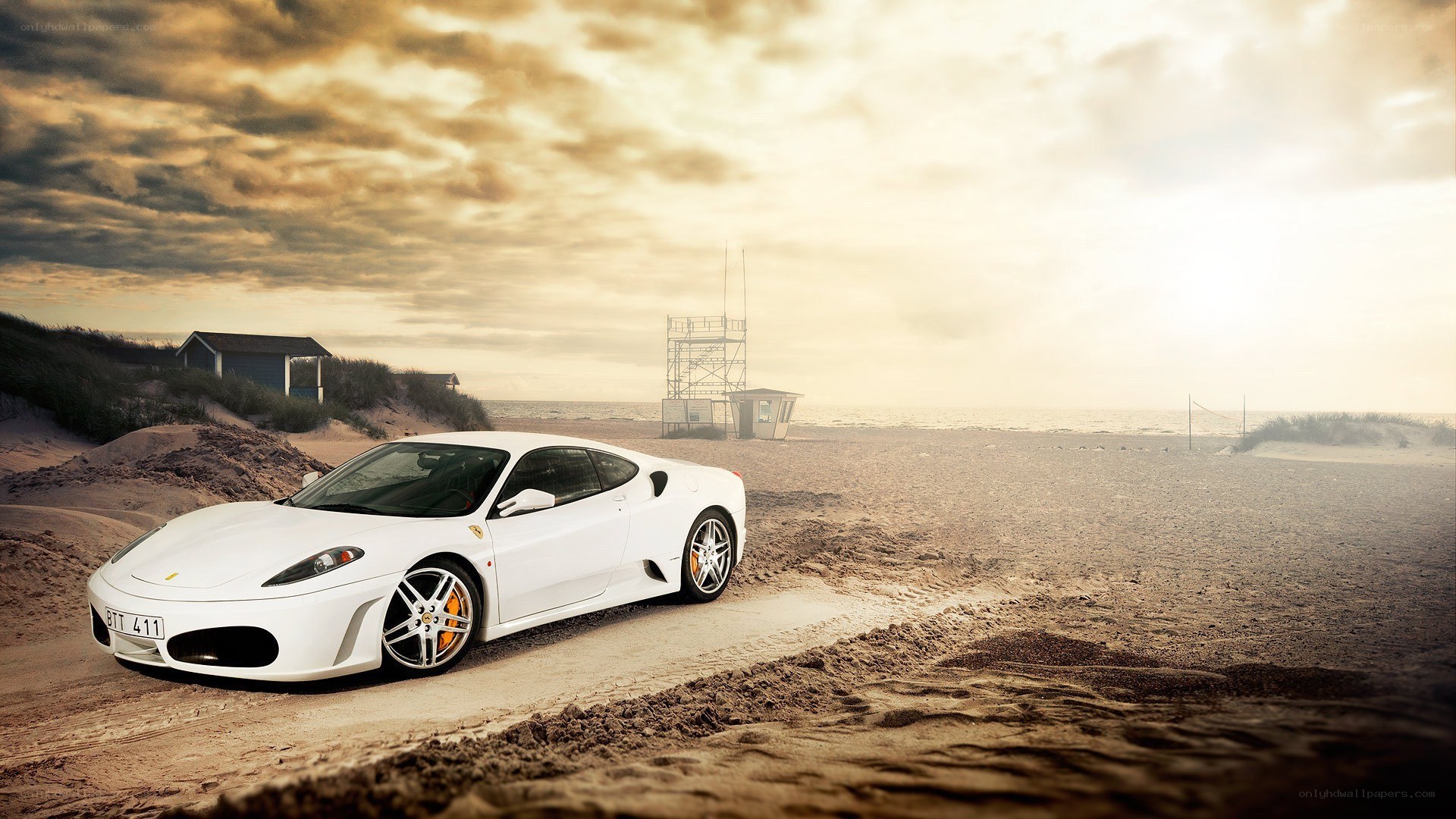 White Ferrari on a sandy beach