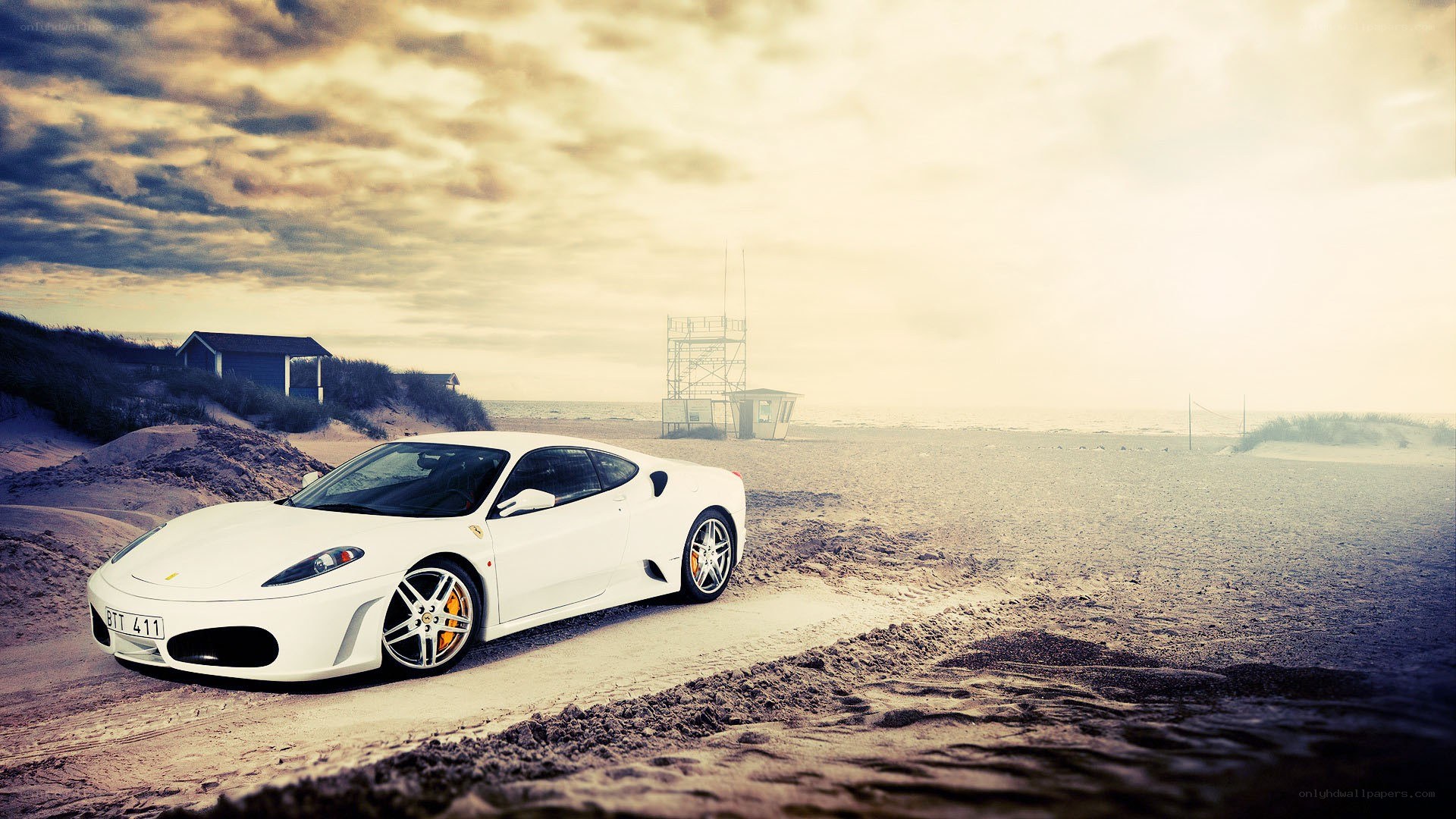 White Ferrari on a sandy beach