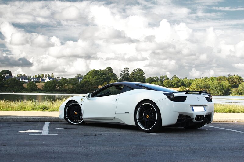 White Ferrari parked by a lake