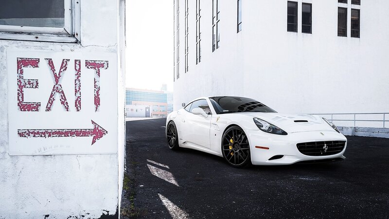 White Ferrari parked near exit sign