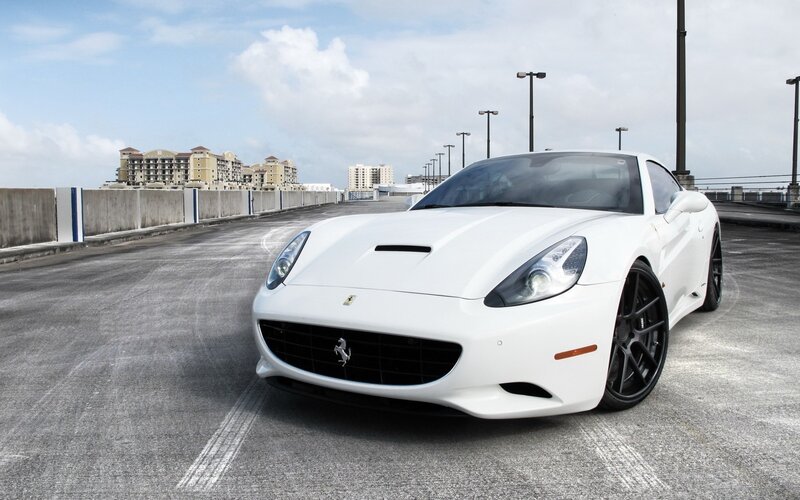White Ferrari parked on a bridge