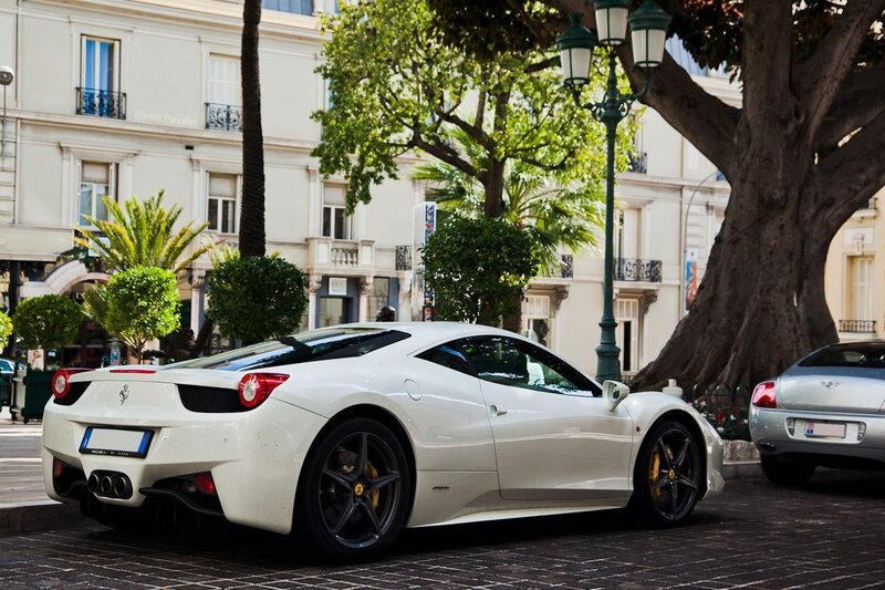 White Ferrari parked on a city street