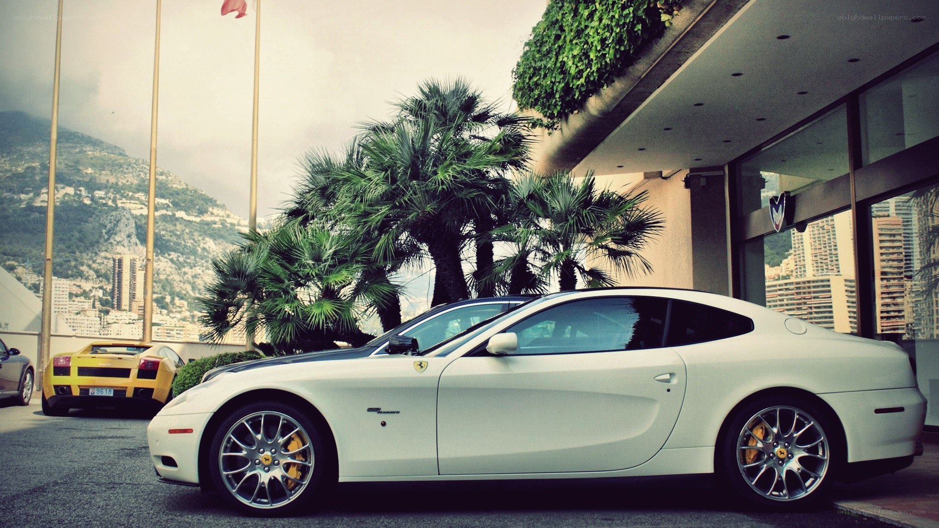 White Ferrari parked outside hotel