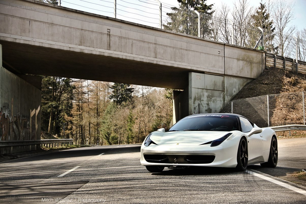 White Ferrari under a bridge