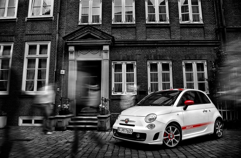 White Fiat Abarth on cobblestone street