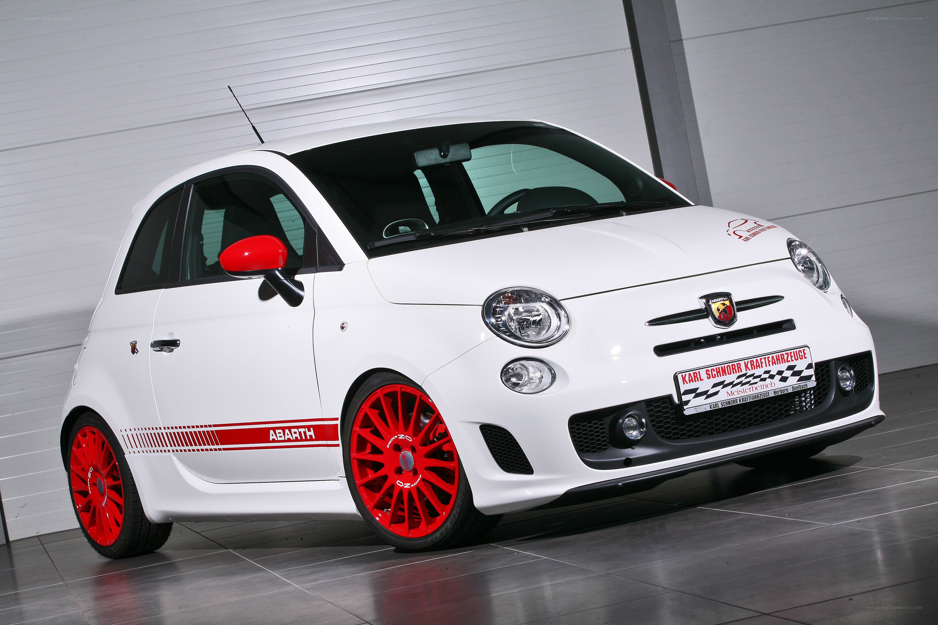 white fiat abarth with red wheels