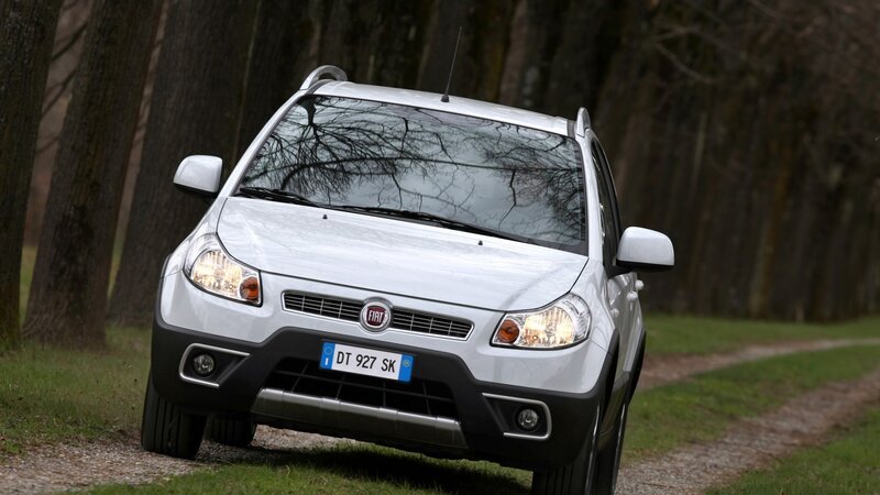 white fiat crossover on dirt road