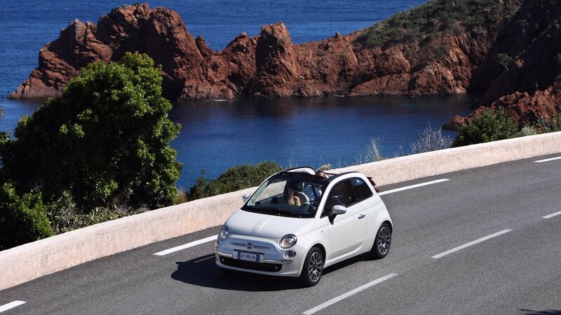 White Fiat on coastal road