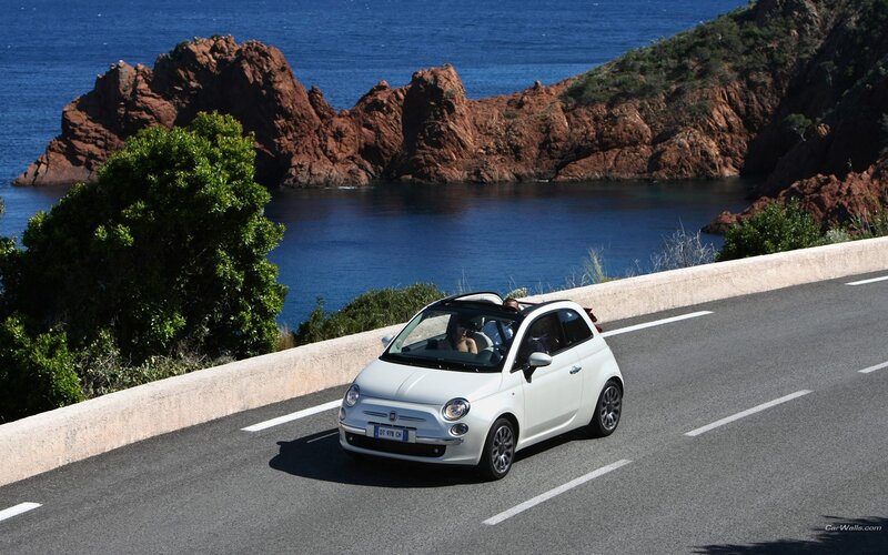 White Fiat on coastal road