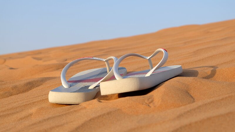 White Flip-flops on Sand
