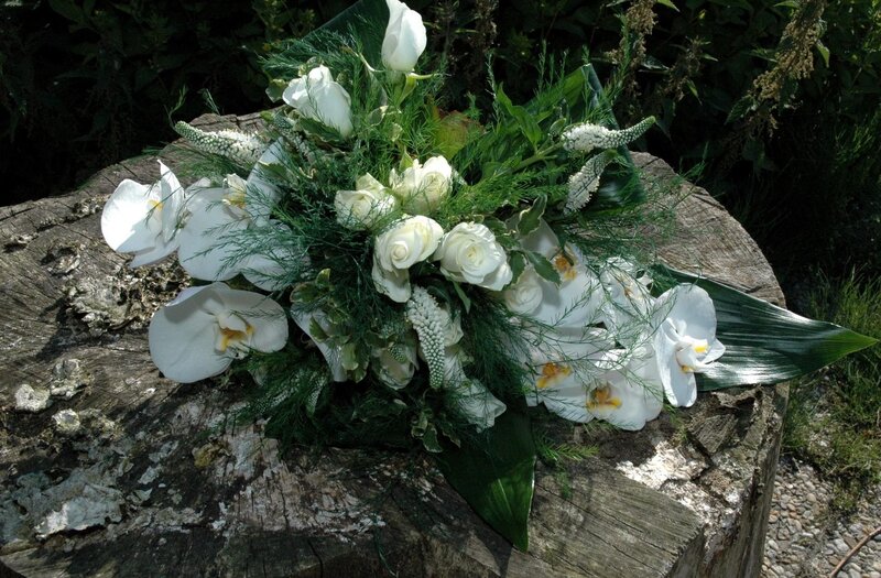 White floral arrangement on stump