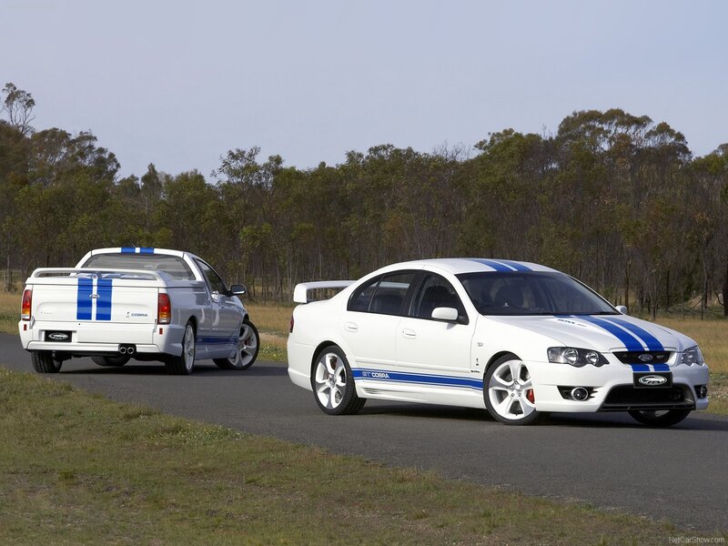 White Ford Cobra cars on road