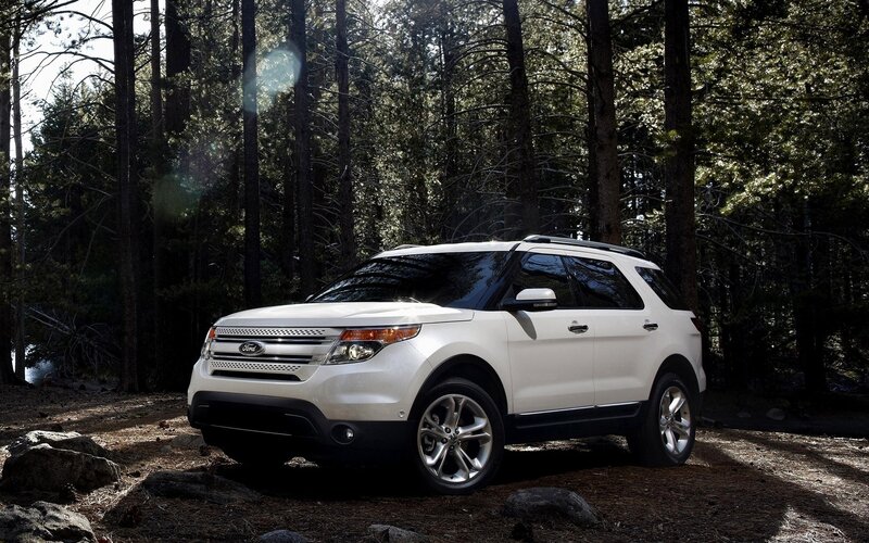White Ford Explorer in forest