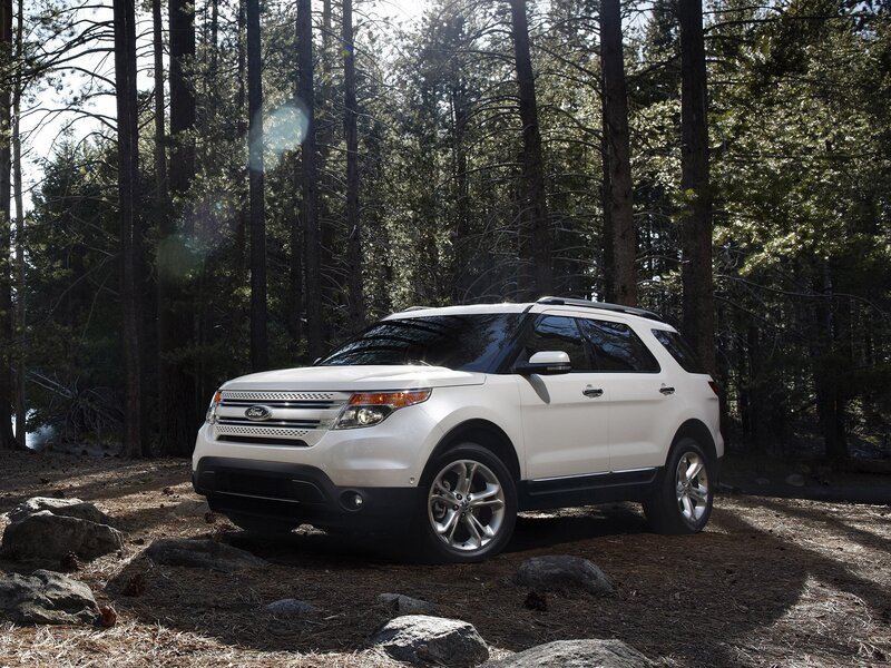 White Ford Explorer in forest