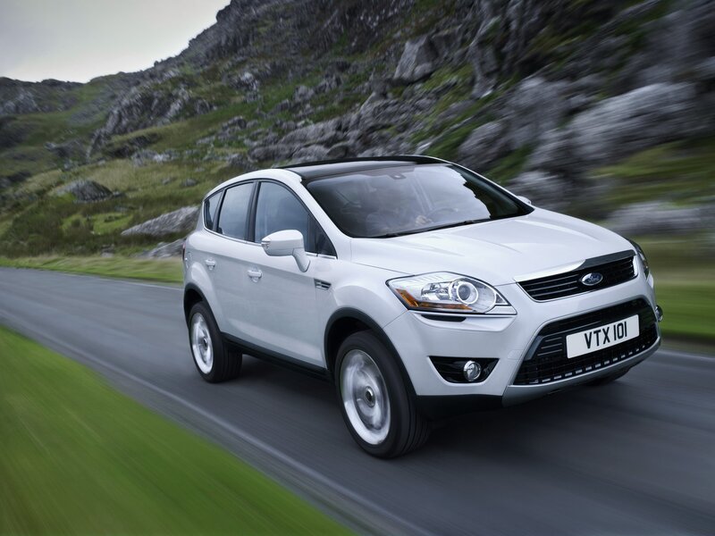 White Ford Kuga driving on a road
