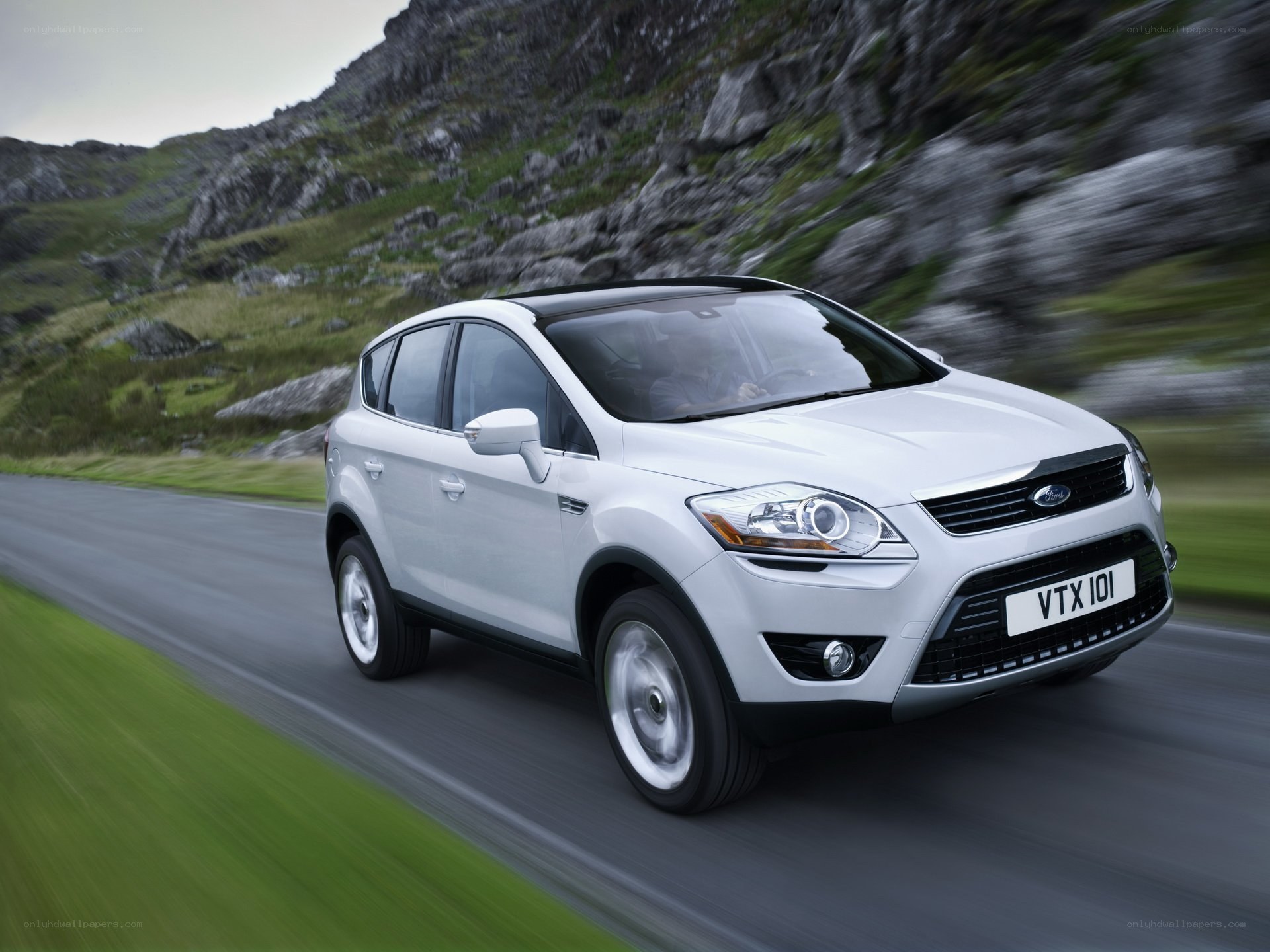 White Ford Kuga driving on a road