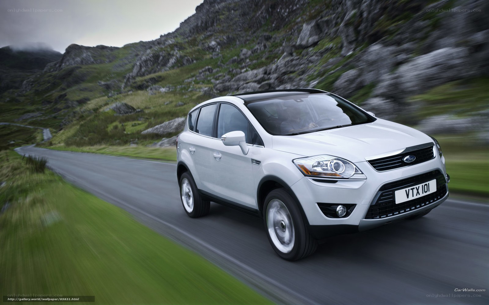 white ford kuga driving on mountain road