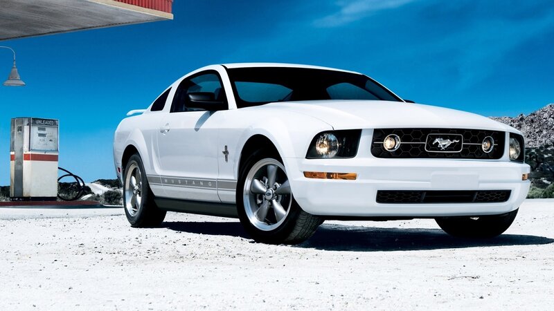 White Ford Mustang at gas station