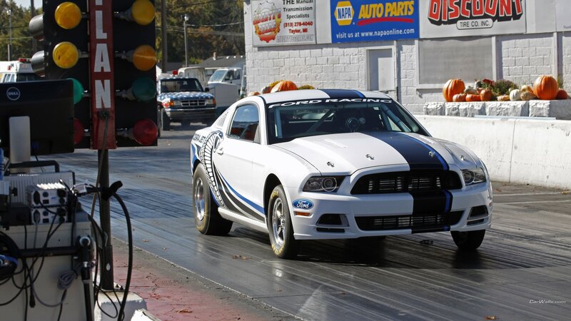 White Ford Mustang on a drag strip