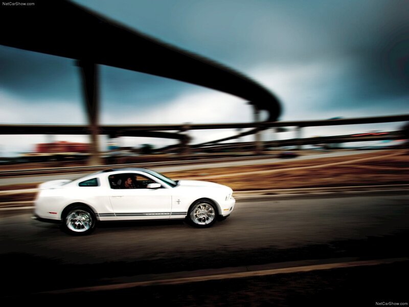 White Ford Mustang on a highway