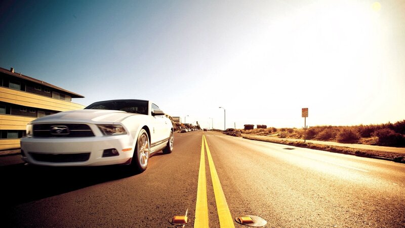 White Ford Mustang on coastal road