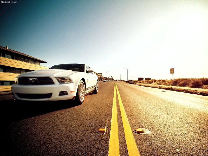 White Ford Mustang on coastal road