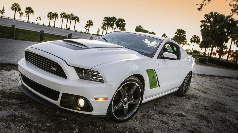 white ford mustang on dirt