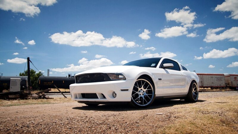 White Ford Mustang on gravel