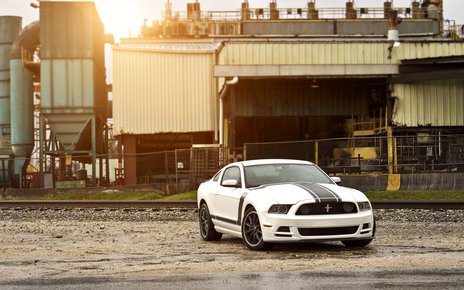 White Ford Mustang on train tracks