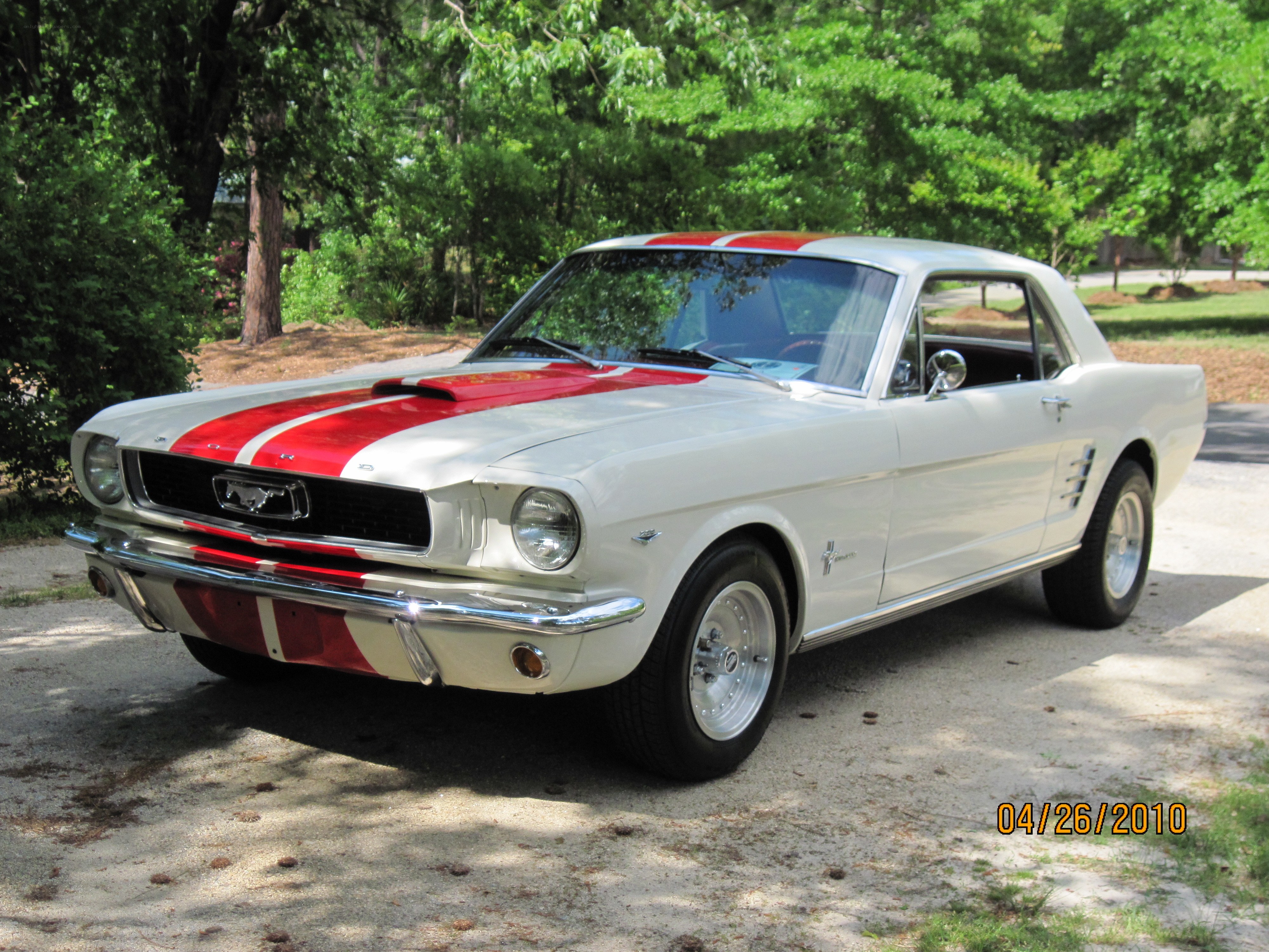 White Ford Mustang with red stripes