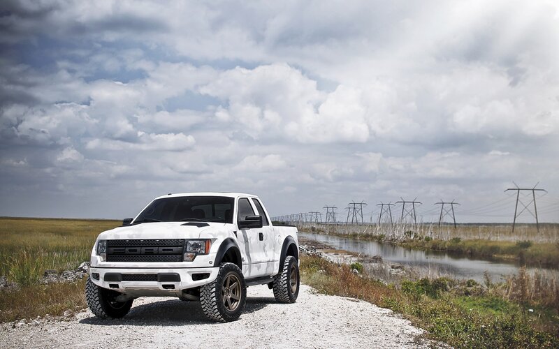 White Ford Raptor on gravel road