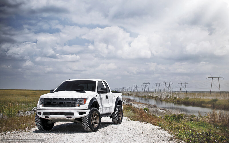 White Ford Raptor on gravel road