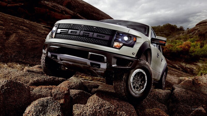 white ford raptor on rocks
