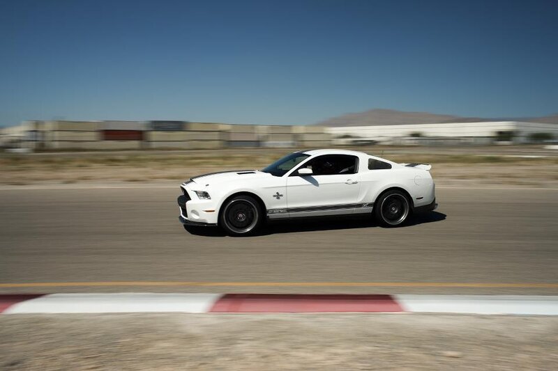 white ford shelby mustang on track