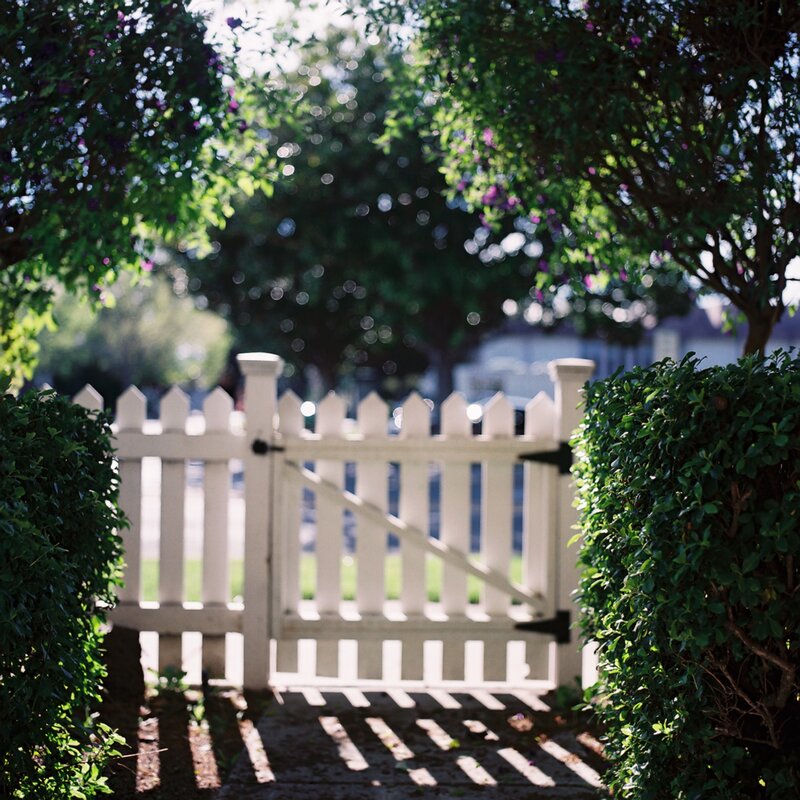 White gate in garden path