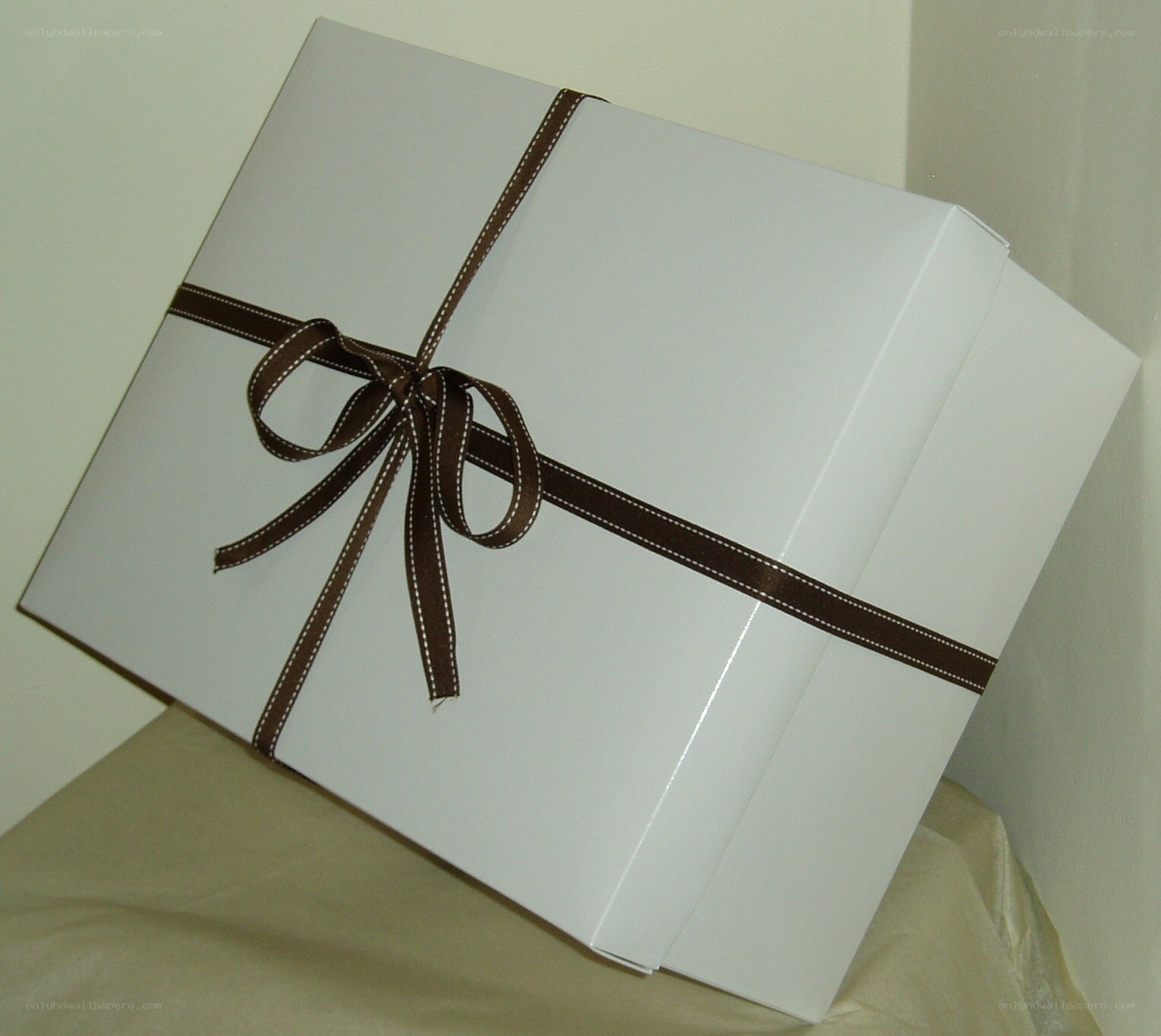 white gift box with brown ribbon