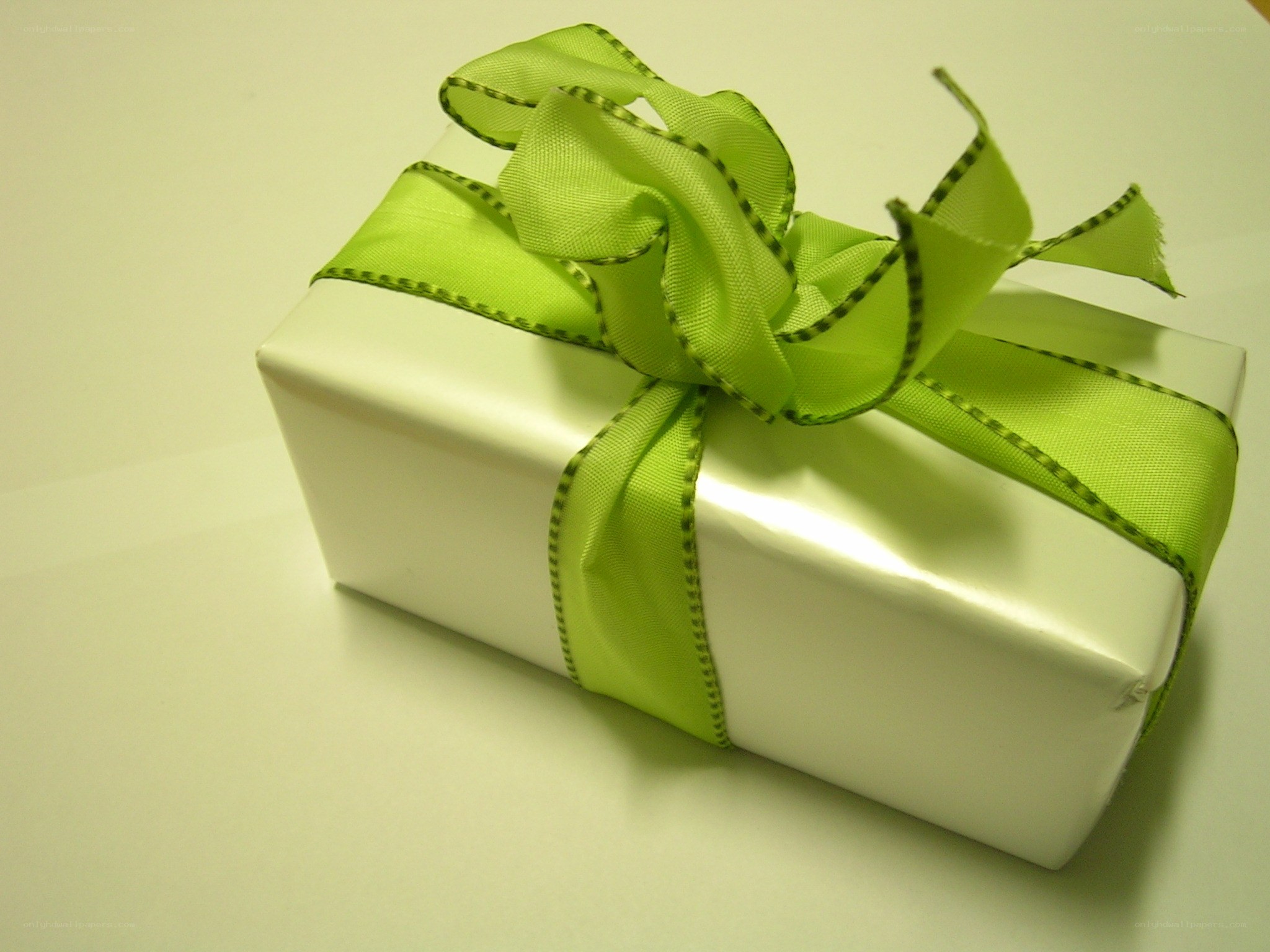 White gift box with green ribbon