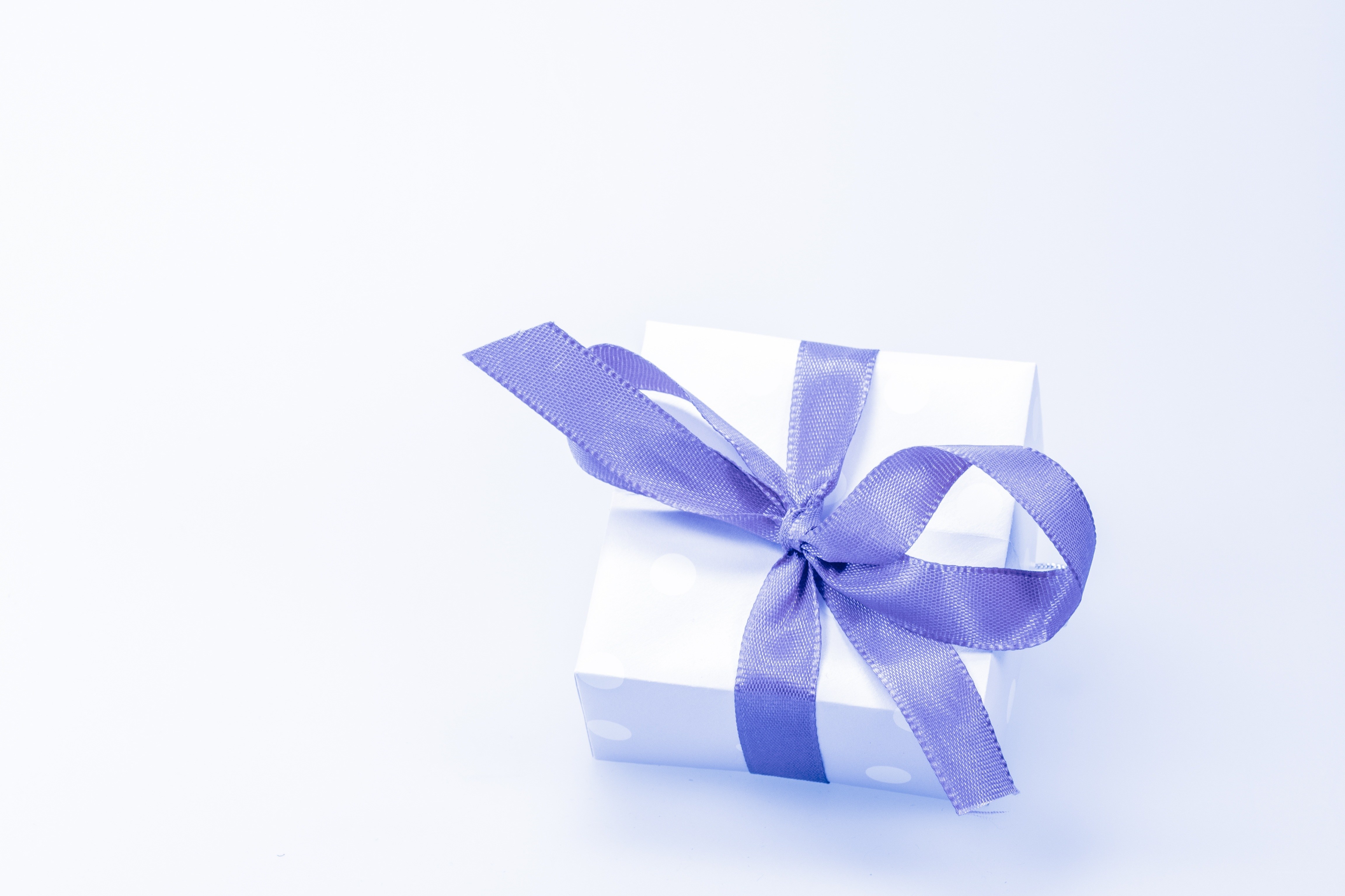 white gift box with purple ribbon