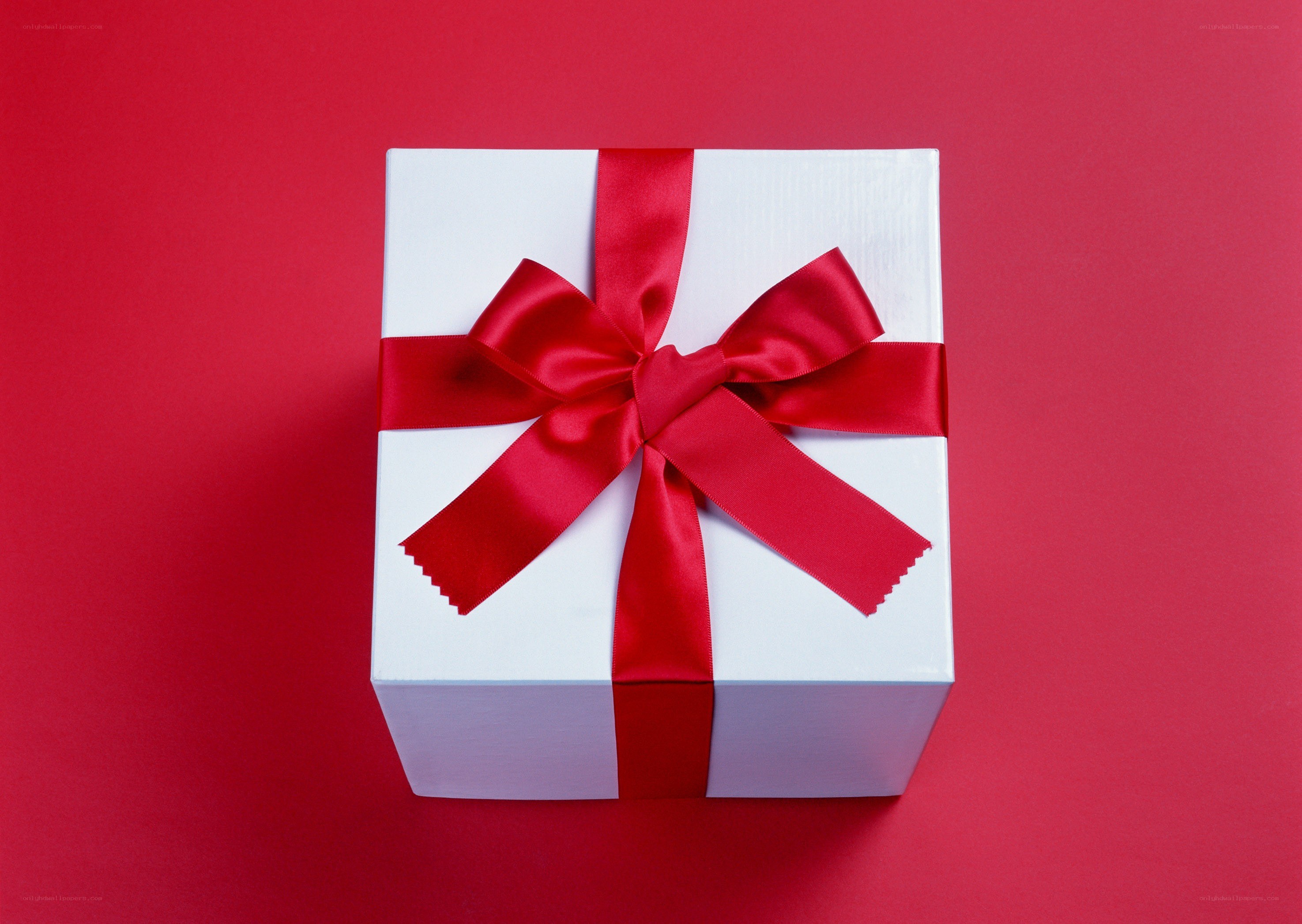 white gift box with red bow