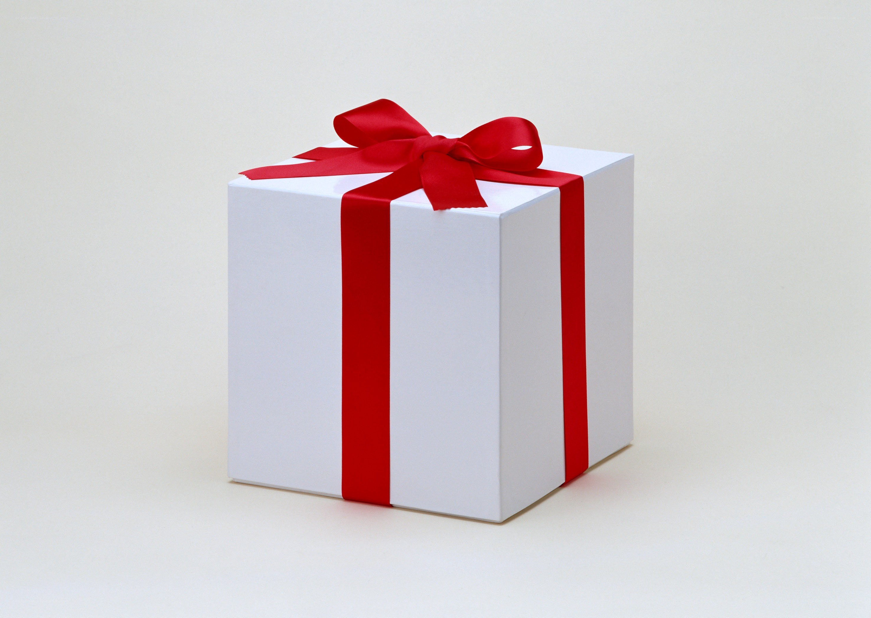 white gift box with red ribbon
