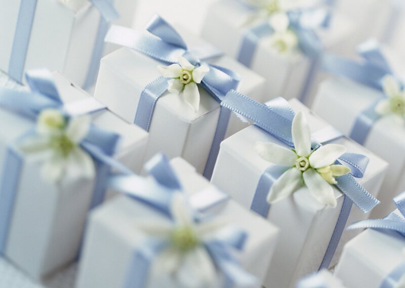 White gift boxes with blue ribbons