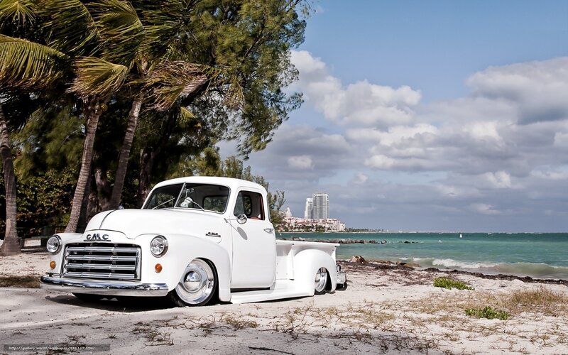 White GMC truck on beach