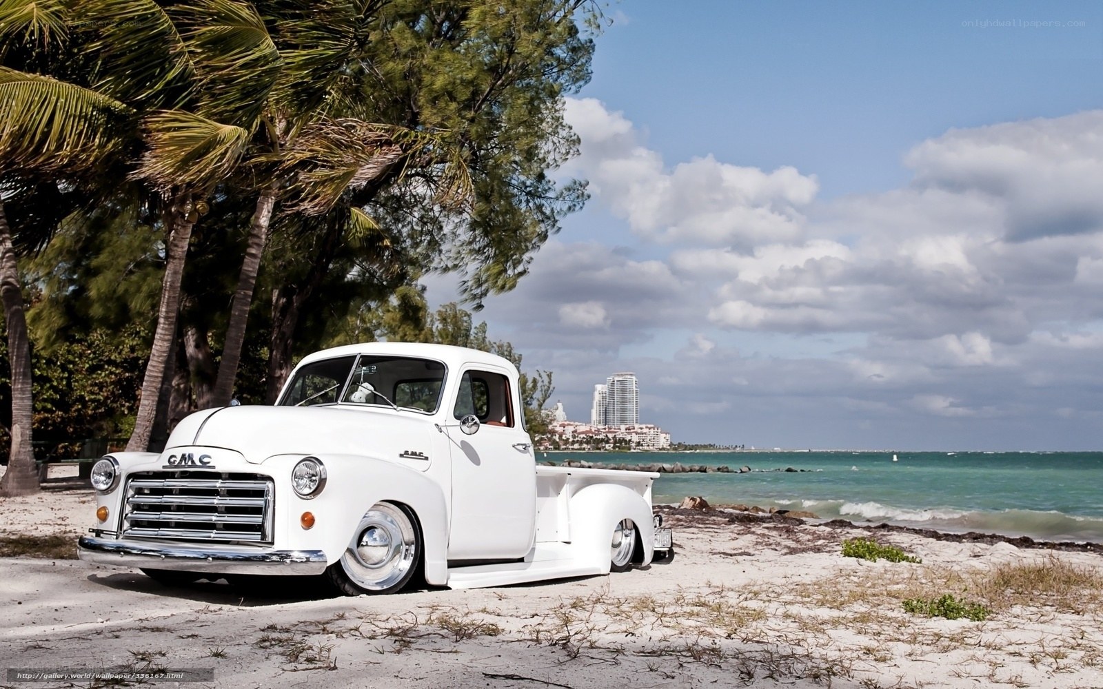 White GMC truck on beach