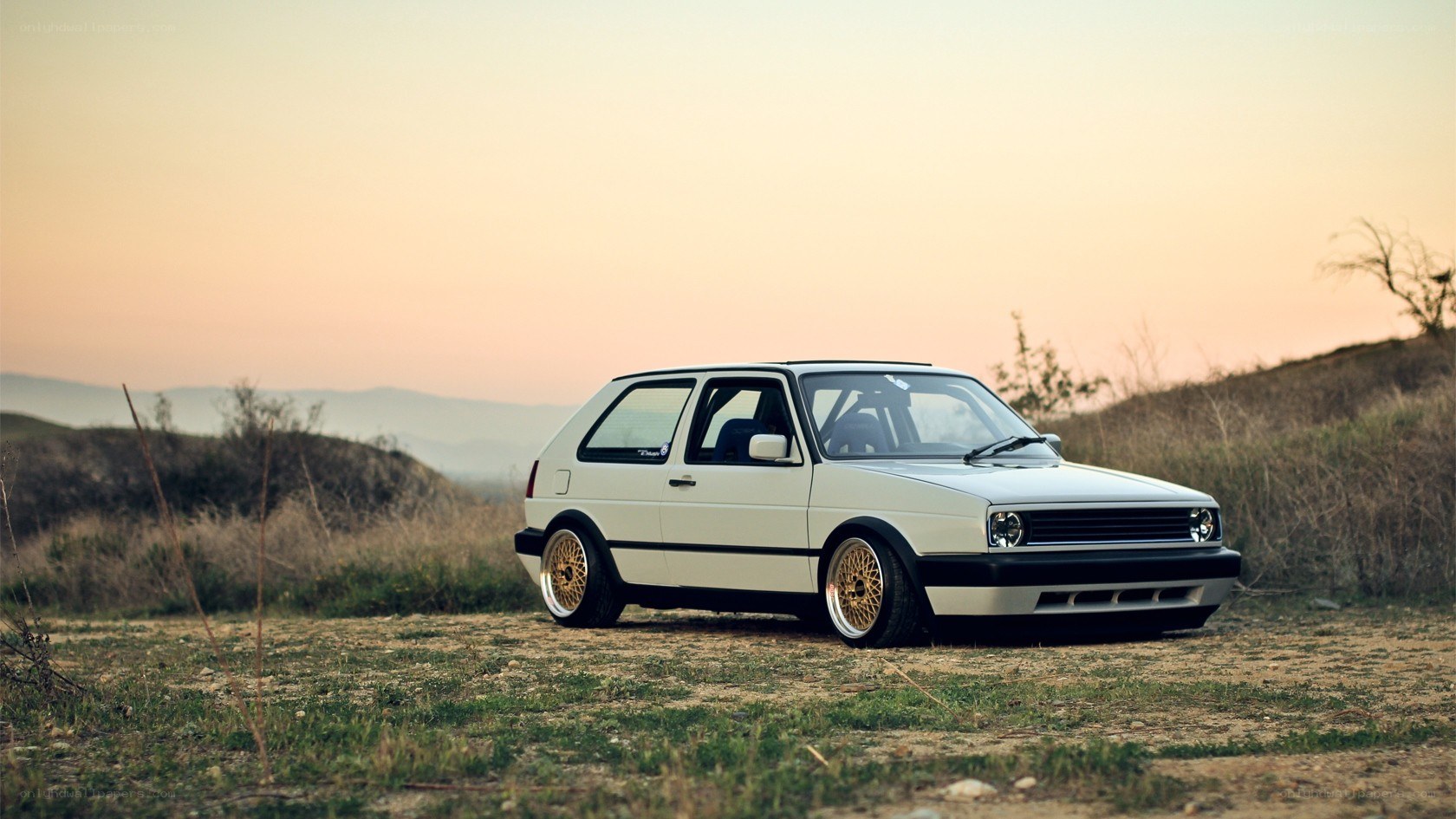 White Golf GTI in a field