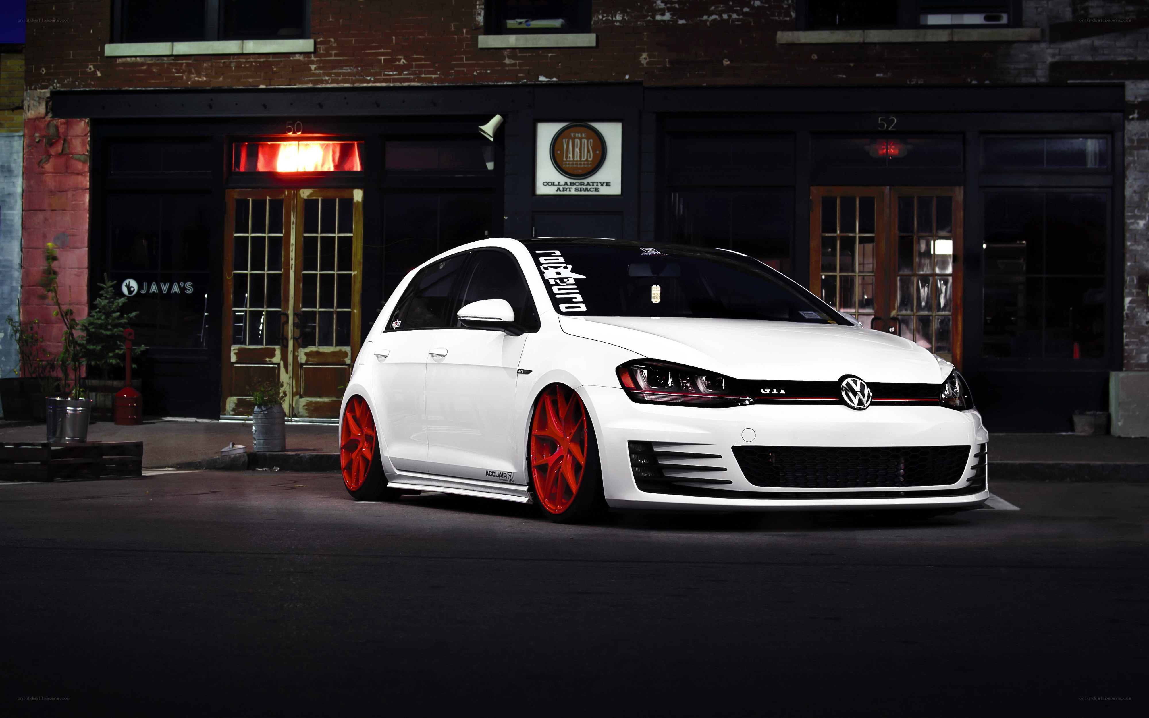 White Golf GTI on city street