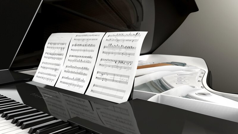 white grand piano with sheet music