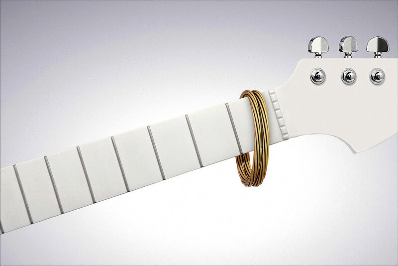 white guitar neck with gold coil