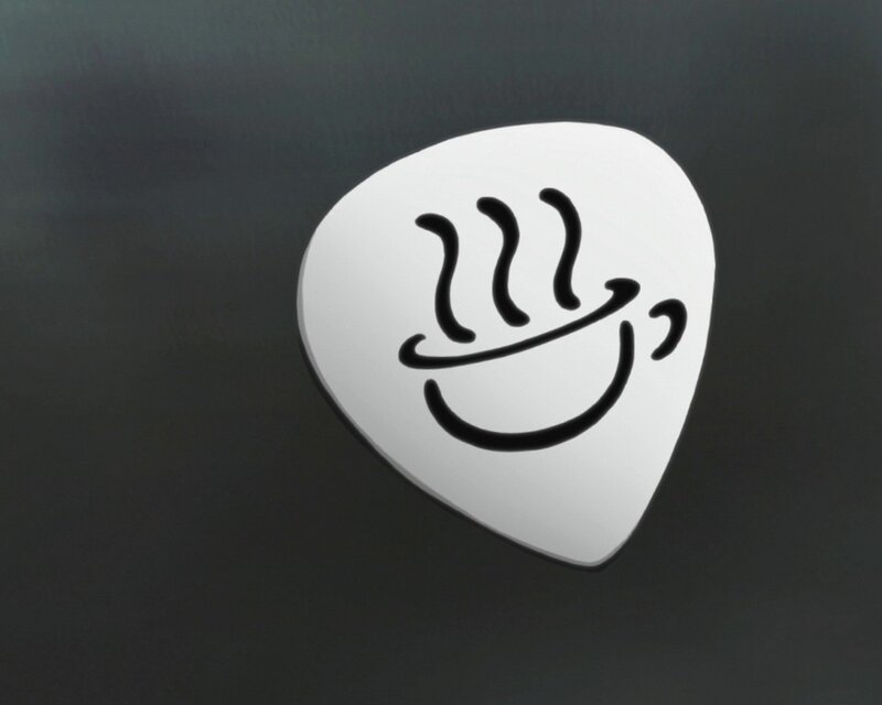 white guitar pick with smiley face