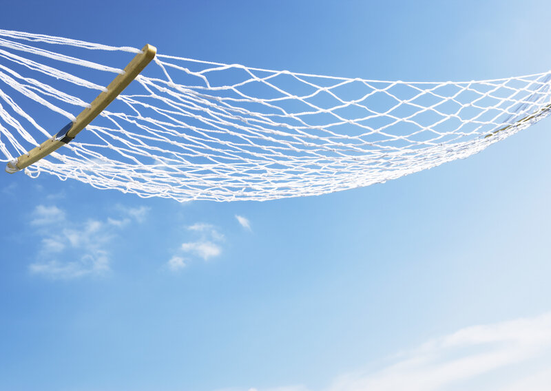 White hammock against blue sky